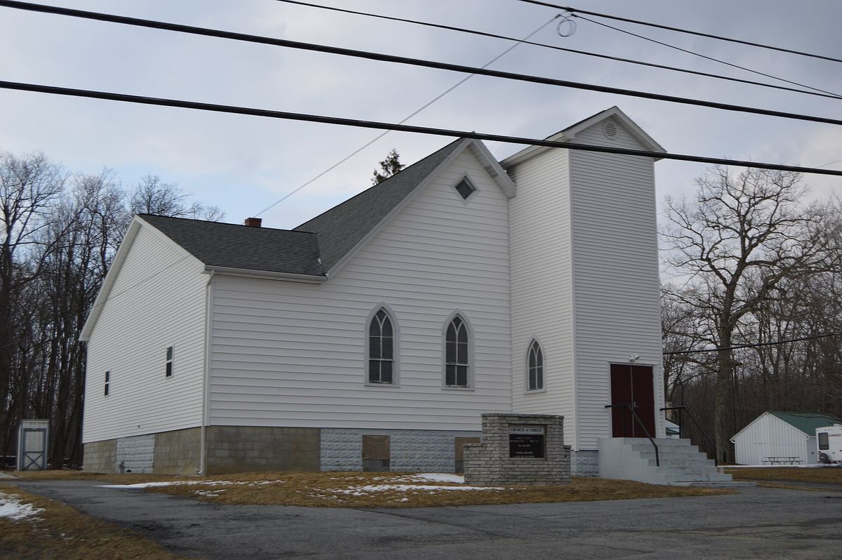Western side and front of the Broad Top Church of Christ, located at 5117 Railroad Avenue (Pennsylvania Route 913) in Broad Top City, Pennsylvania, United States.