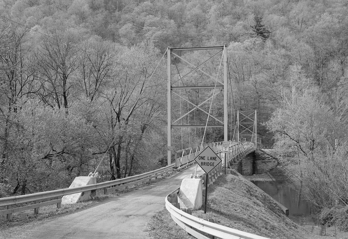 Eastern end of the Corbin Bridge, which carries Township Road 428 over the Raystown Branch Juniata River southwest of Huntingdon in Juniata Township, Huntingdon County, Pennsylvania, United States. Built in 1937, this su
